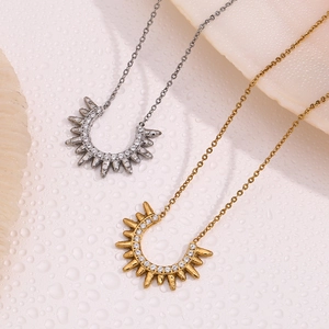 Detailed view of silver and gold sunray necklaces with sparkling zircon stones
