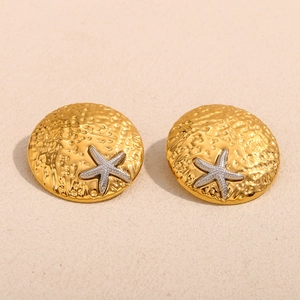 Macro detail of two-tone starfish stud earrings with hammered gold finish and silver relief