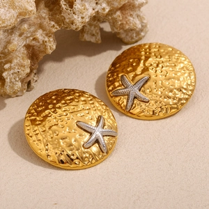 Gold stainless steel shield earrings with silver starfish detail and hammered texture