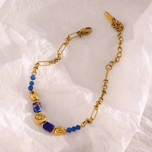 Detail view of 18K gold-plated stainless steel chain with blue stone beads and lobster clasp