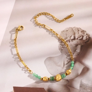 Detail of 18K gold plated chain with green natural stones and textured beads