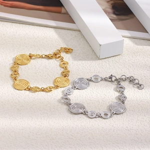 Gros plan de bracelets spirales en acier inoxydable doré et argenté style coquillage