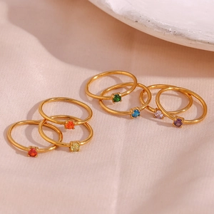 Close-up of minimalist 18K gold plated rings with colorful square birthstones