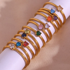 Detailed view of 18K gold plated thin rings with various colorful round birthstones