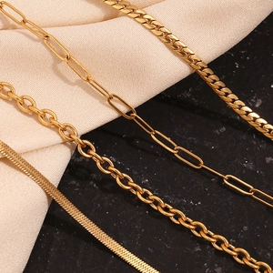 Macro view of various 18K gold-plated stainless steel necklaces with polished chains
