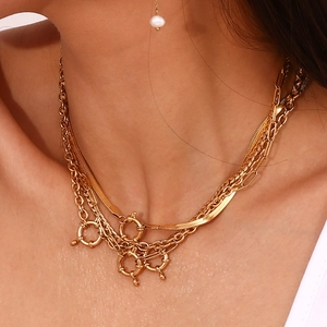 Close-up of layered 18K gold plated stainless steel necklace with round spring clasps