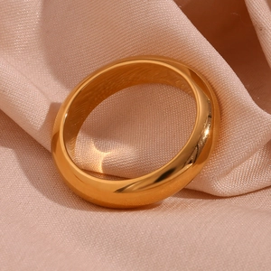 Macro view of thick 18K gold plated stainless steel band on pink satin fabric