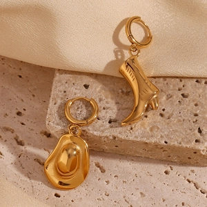 Detail shot of asymmetric 18K gold plated stainless steel cowboy boot and hat earrings