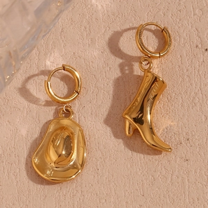 Detail showing high-polished 18K gold-plated cowboy hat and western boot earring drops