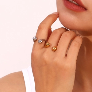 Detail of minimalist 18K gold and silver plated open rings with teardrop ends on hand