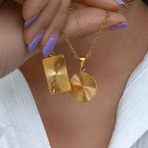 Gold plated stainless steel necklace set with sunburst engraved rectangle and round pendants