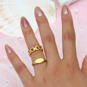 Detail of 18K gold plated ring with engraved 333 number on shell and pearl background