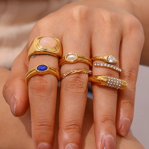 Detail of 18K gold-plated vintage ring set featuring natural stones and pearls on hand