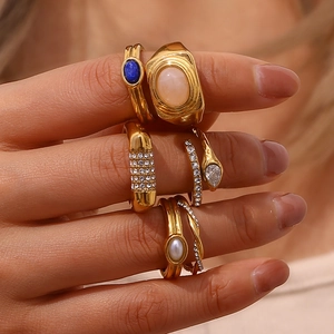 Detail of 18K gold plated ring set with natural blue and pink stones and micro-pave crystals
