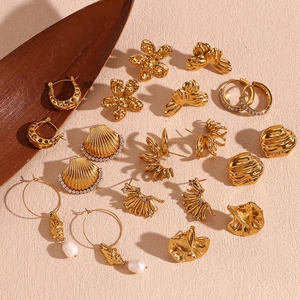 Detailed close-up of vintage 18K gold plated earrings with pearls and lava textures