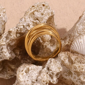 Detailed view of the 18K gold plated triple layered woven textured ring on a stone