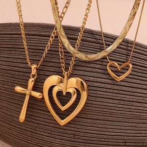 Close-up of 18K gold-plated stainless steel hollow heart and cross pendant necklaces