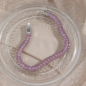 Detailed macro view of pink zircon bracelet with silver metal and secure folding clasp