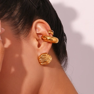Detail of 18K gold plated stainless steel stud and ear cuff set on a model