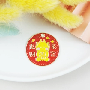 Detail of red enamel dragon charm with Chinese characters for wealth and luck