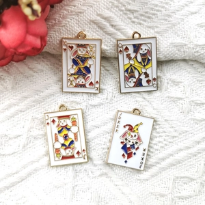 Macro view of four enamel rabbit poker charms with gold-plated edges for DIY jewelry