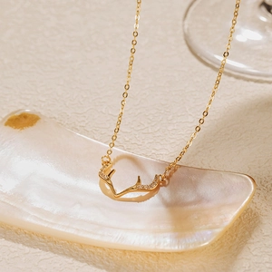 Vue détaillée du pendentif en bois de cerf doré orné de zircons blancs étincelants