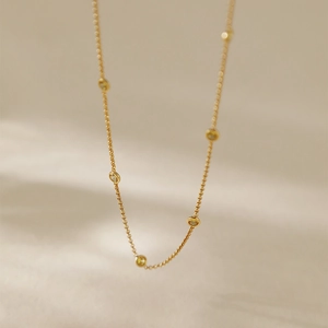 Minimalist vintage gold chain necklace featuring bezel-set round zircon gemstones