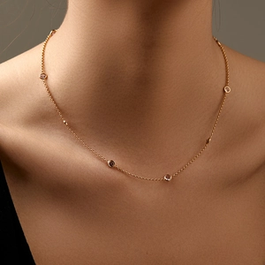 Classic 18K gold plated brass necklace with sparkling pink zircon on a female model