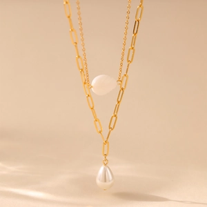 Detail of double-layer gold necklace with oval opal and teardrop pearl pendant