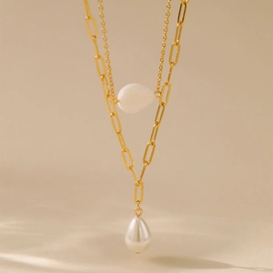 Detail of double-layer gold chain with white leaf bead and drop pearl pendant