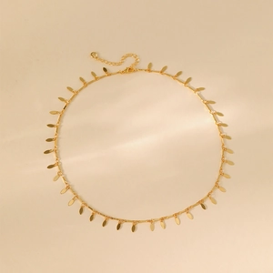 Detail of double-layer gold necklace showing leaf charms and adjustable lobster clasp