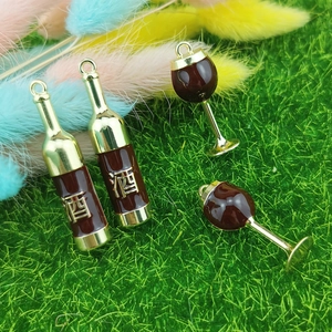 DIY jewelry charms featuring red wine bottles and goblets with gold finish and red enamel