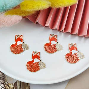 DIY fox enamel charms with orange and white finish on a white tray, 4 pieces set