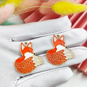 DIY fox keychain charms in orange and white enamel with golden metal details