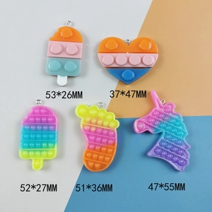 Silicone unicorn and heart fidget toy keychains in various colorful rainbow designs