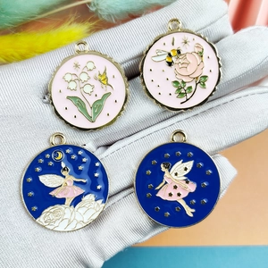 Round enamel charms set featuring floral, bee, and fairy designs in pink and blue tones