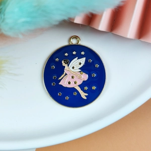 Macro view of blue enamel fairy pendant with golden stars on a white ceramic plate