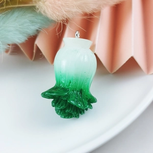 Macro shot of 3D resin cabbage pendant with white-green gradient and silver metal ring