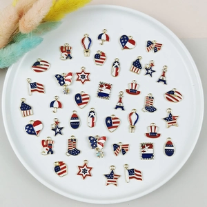 DIY American Flag enamel charms set with stars and bows on a white round display tray