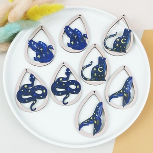 Starry sky wooden teardrop charms featuring swan, cat, snake, and whale patterns