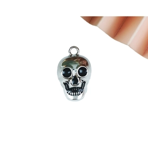 Polished silver alloy skull pendant with black enamel eyes and nose for jewelry making