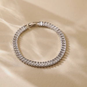 Detail of elegant silver tennis bracelet featuring rectangular baguette-cut zircons