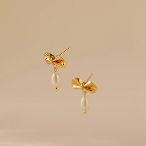 Elegant 18K gold plated bow earrings with white teardrop pearls for a minimalist look