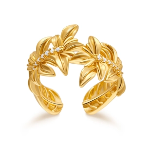 Macro shot of gold floral open ring with crystal leaf details and polished finish