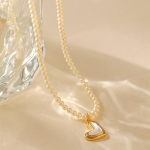 Klassieke vergulde hartjesketting met elegante parels en iriserende parelmoer inlegwerk