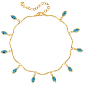Detail view of gold anklet featuring marquise-cut blue zircon drops and lobster clasp