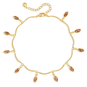Close-up of golden anklet featuring marquise-cut amber stone pendants and lobster clasp