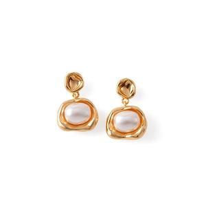 Detail of vintage irregular gold geometric frame earrings with large oval white pearls
