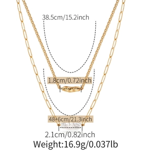 Detailed view of layered necklace with gold bar pendant and baroque pearl charm