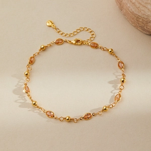 Detail of 18K gold plated anklet with orange gemstones and adjustable lobster clasp closure